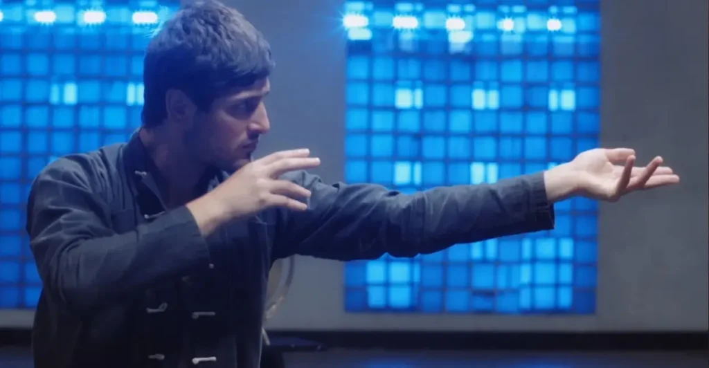Cena do filme brasileiro O Mestre da Fumaça (2023), com o personagem Max, interpretado por Daniel Rocha, em posição de luta durante treinamento de artes marciais, diante de um fundo iluminado por luzes azuis — destaque para a fusão entre comédia, ação e cultura oriental.