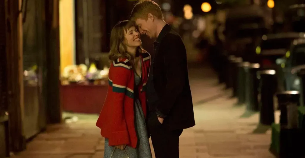 Cena do filme Questão de Tempo (2013), com casal sorrindo apaixonado em um encontro noturno nas ruas de Londres — romance com viagem no tempo e momentos emocionantes.